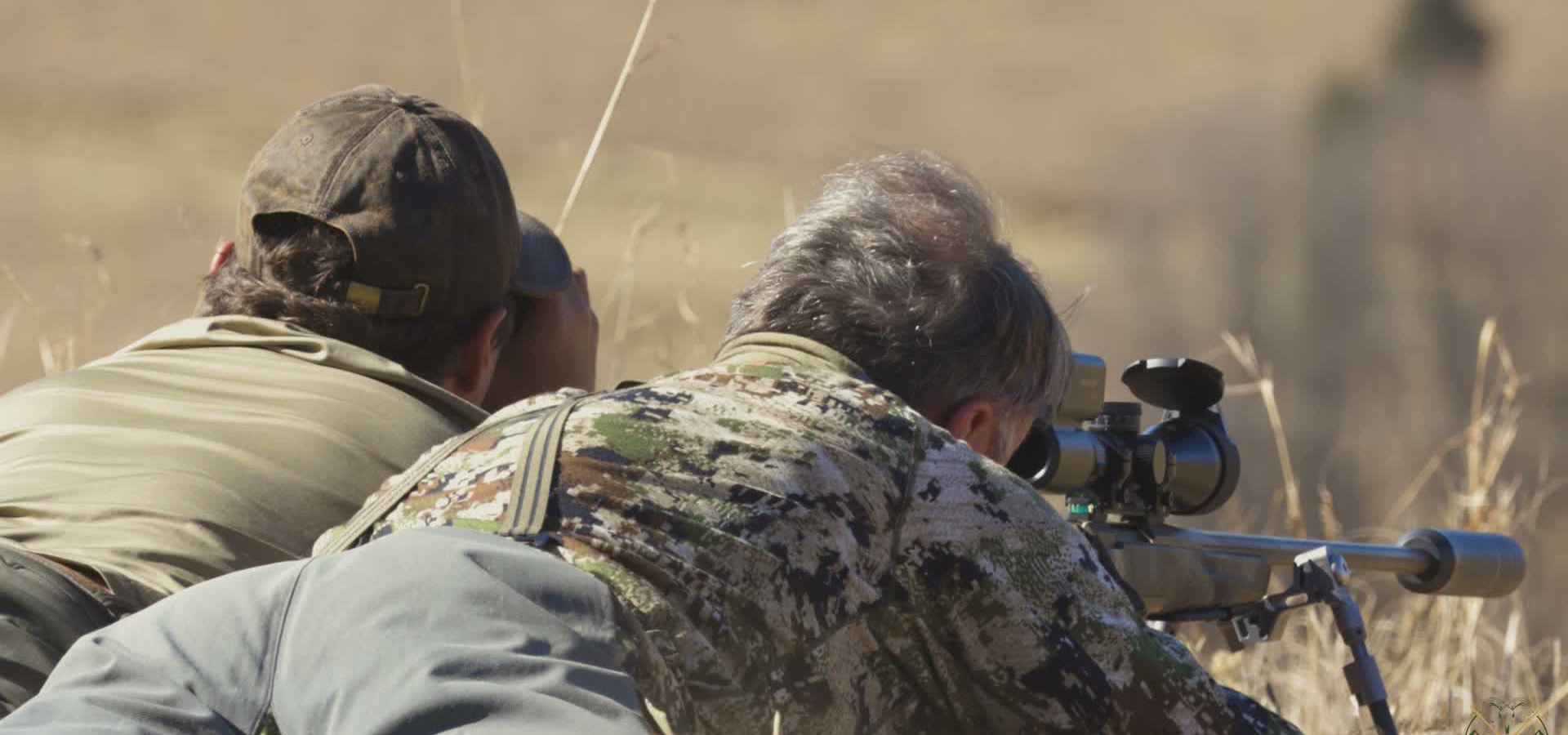 Two hunters glassing the veld at first light
